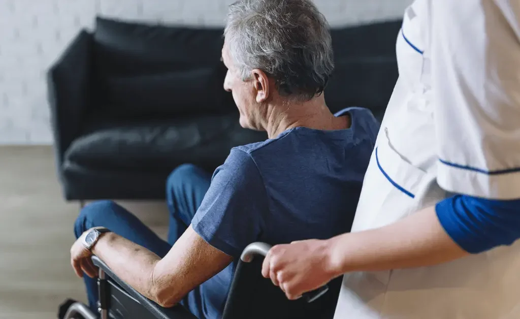 moving an old man in a wheelchair